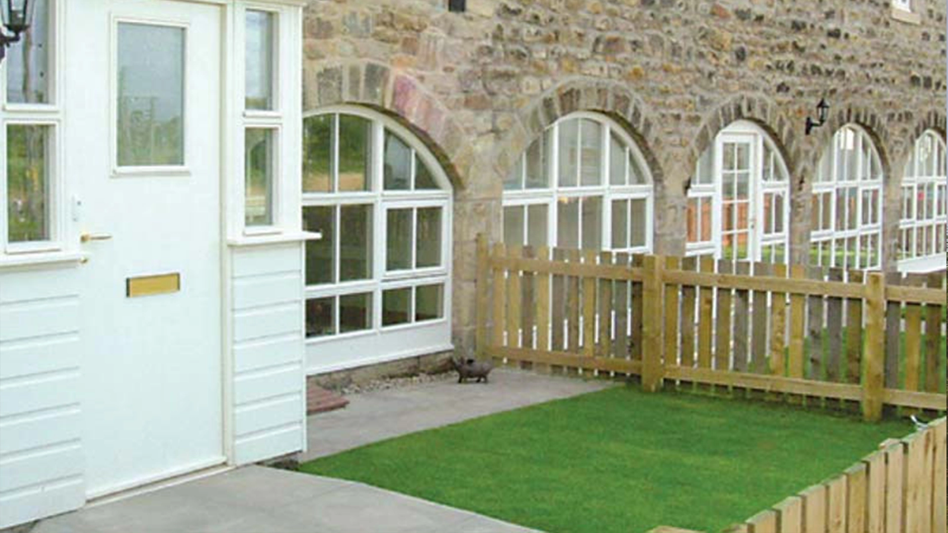 timber-storm-windows-outside-looking-at-windows-on-the-floor-in-an-arch-shape-fitted-in-bracknell