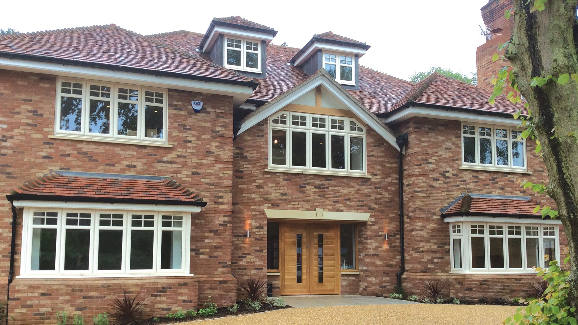 alternative-to-timber-outside-a-large-house-with-large-windows-over-all-walls-fitted-by-newglaze-windows-doors-conservatories-in-bedfordshire