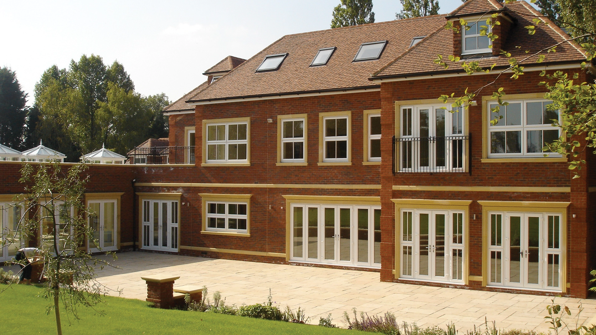 door-spec-outside-looking-at-large-house-with-windows-surrounding-the-house-newglaze-windows-doors-conservatories-in-bedfordshire