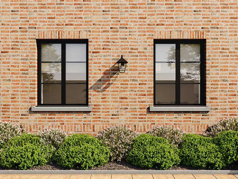 aluminium-heritage-windows-brigh-brick-wall-with-two-small-windows-both-with-metalic-framing-fitted-in-woking