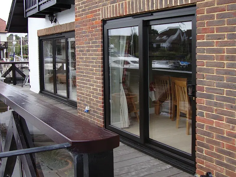 black-patio-sliding-doors-in-a-restaurant-next-to-a-river-fitted-in-woking-by-testinstaller-by-windsor-windows